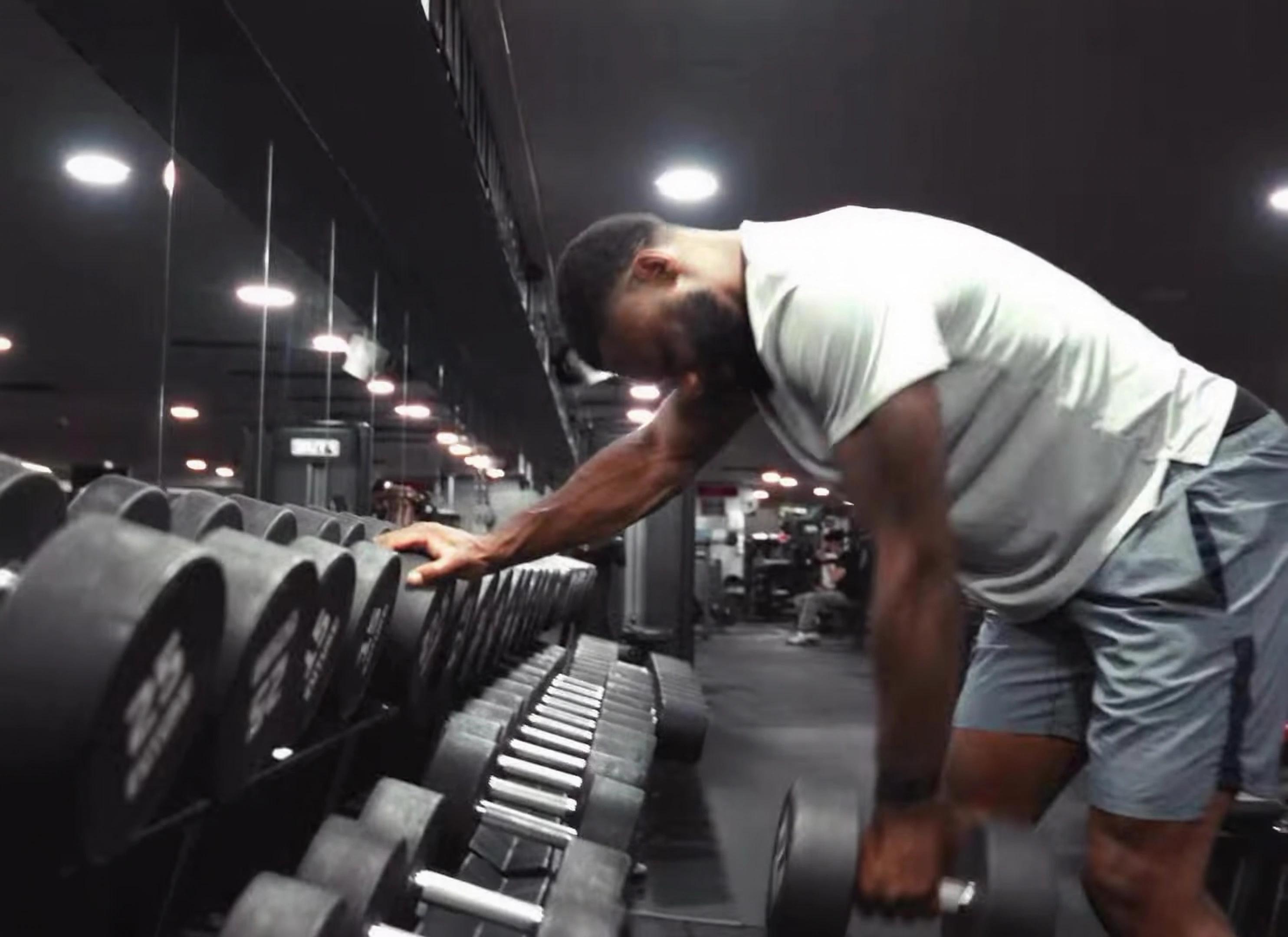 Sam Graham training with dumbbells in the gym